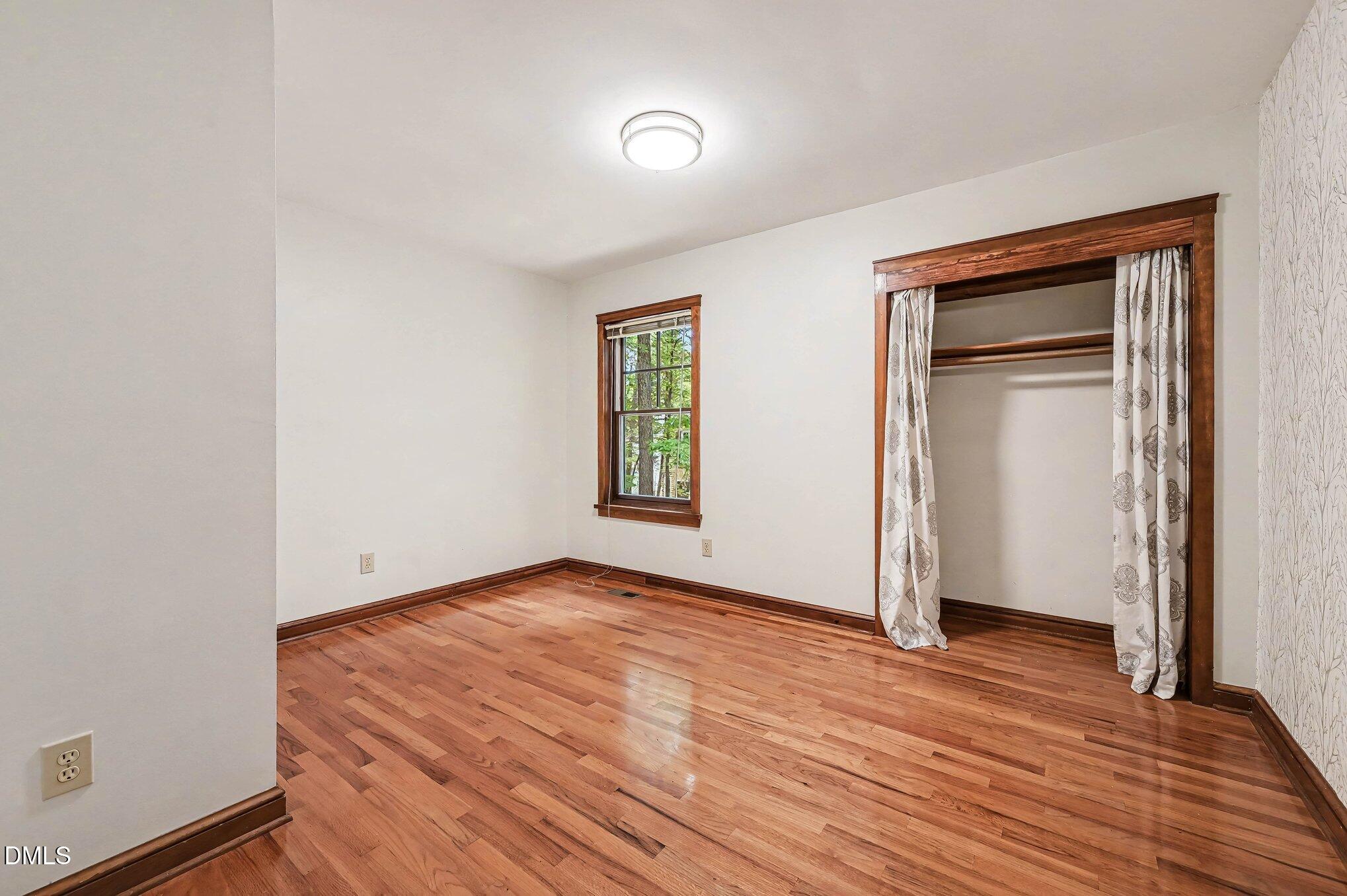 200 Spring Valley Road Carrboro, NC 27510 - Photo 22 of 38 an empty room with wooden floor and windows