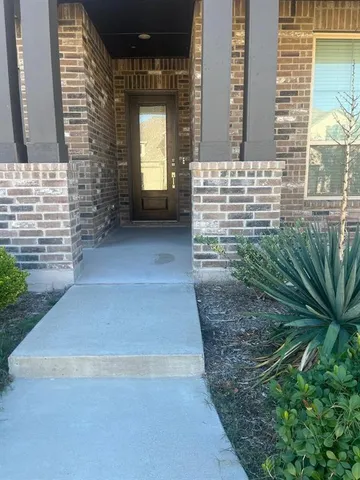 a view of front door of house with yard