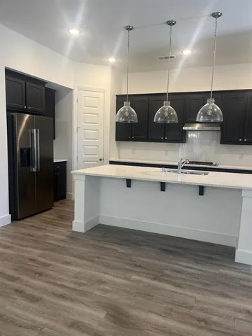 a kitchen with a refrigerator and cabinets