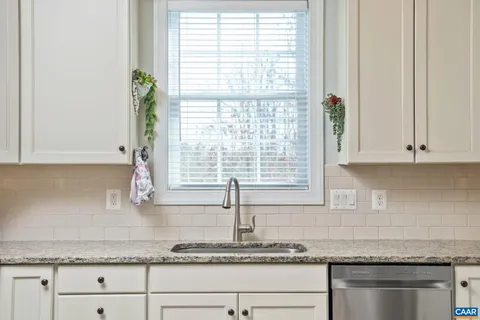 a view of a dining room with furniture kitchen and wooden floor