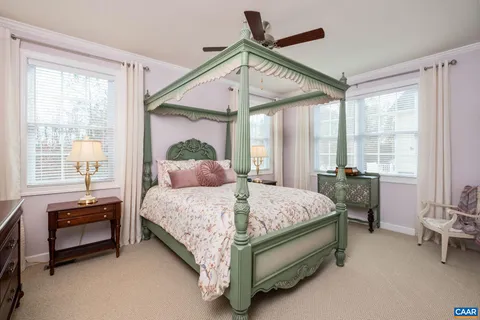 a bedroom with a bed and a mirror on the dresser