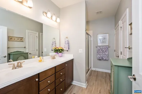 a en suite bathroom with a shower a sink and a mirror