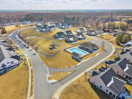 an aerial view of a swimming pool with outdoor seating