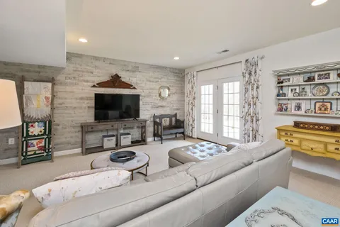 a living room with furniture and kitchen view