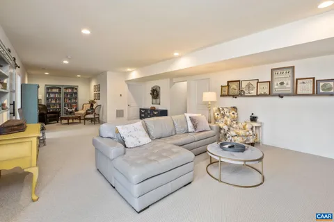 a living room with furniture and book shelf