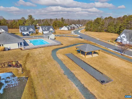 an aerial view of a residential houses with outdoor space