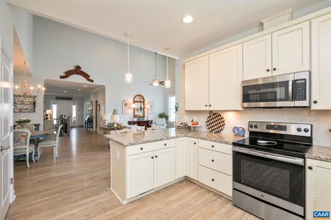 a kitchen with granite countertop stainless steel appliances cabinets a sink and a counter top