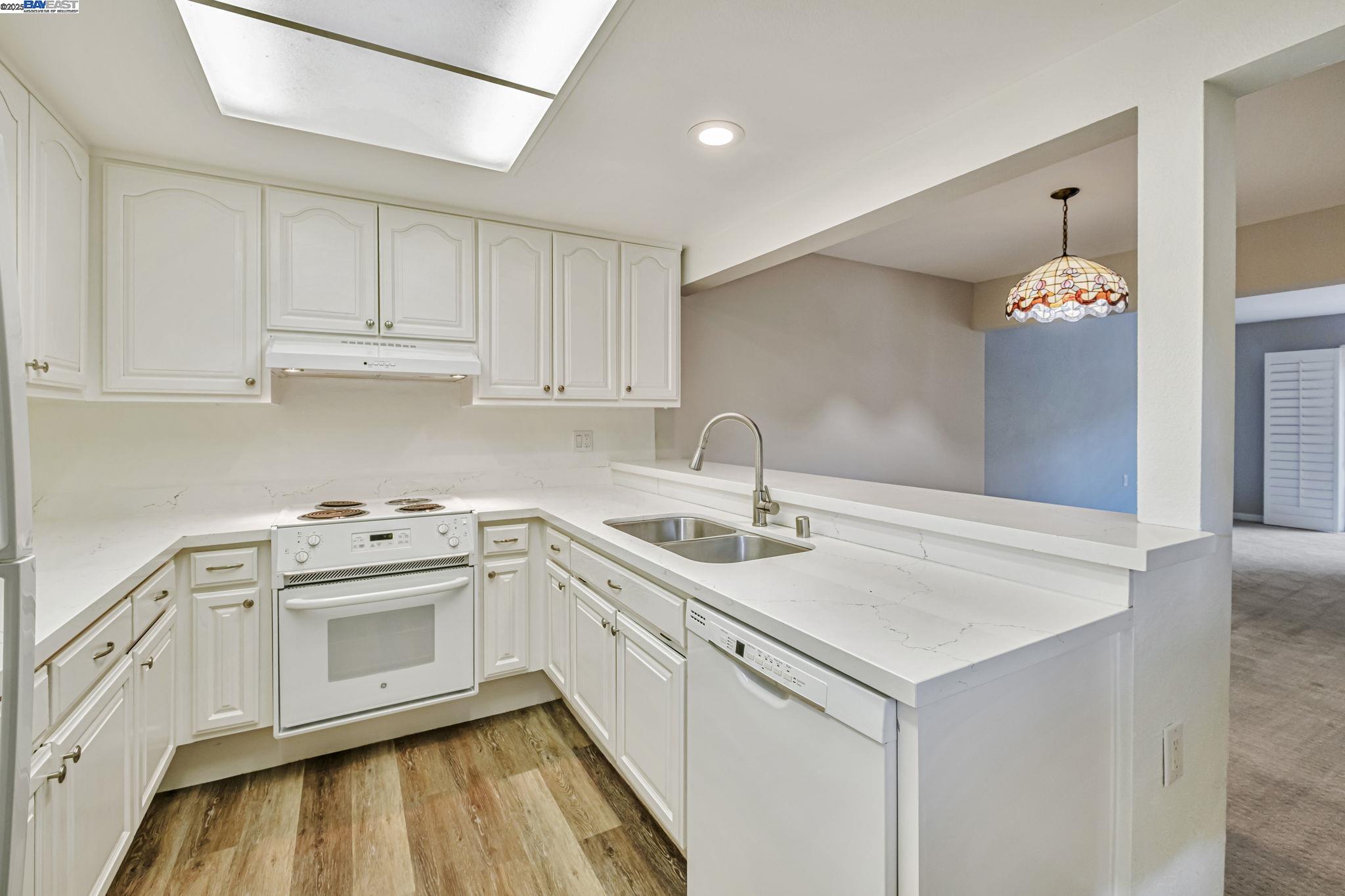 1400 Golden Rain Road, Unit 3 Walnut Creek, CA 94595 - Photo 13 of 29 a kitchen with white cabinets appliances and sink