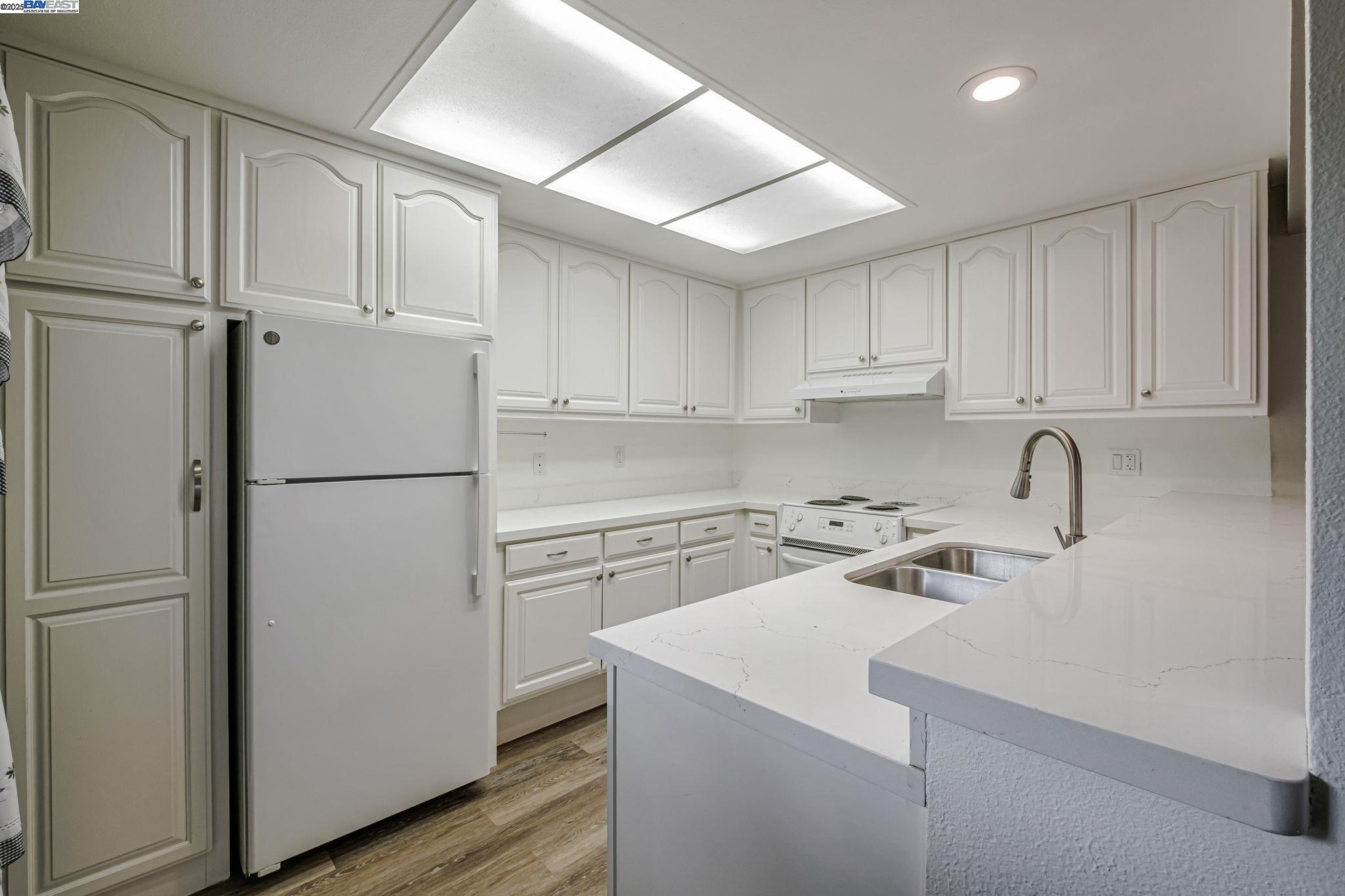 1400 Golden Rain Road, Unit 3 Walnut Creek, CA 94595 - Photo 14 of 29 a kitchen with refrigerator a stove a sink and cabinets