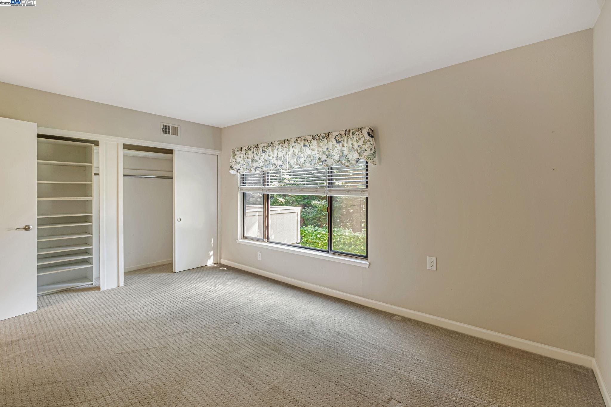 1400 Golden Rain Road, Unit 3 Walnut Creek, CA 94595 - Photo 21 of 29 an empty room with windows and closet