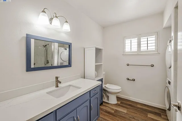 a bathroom with a toilet a sink a vanity and mirror