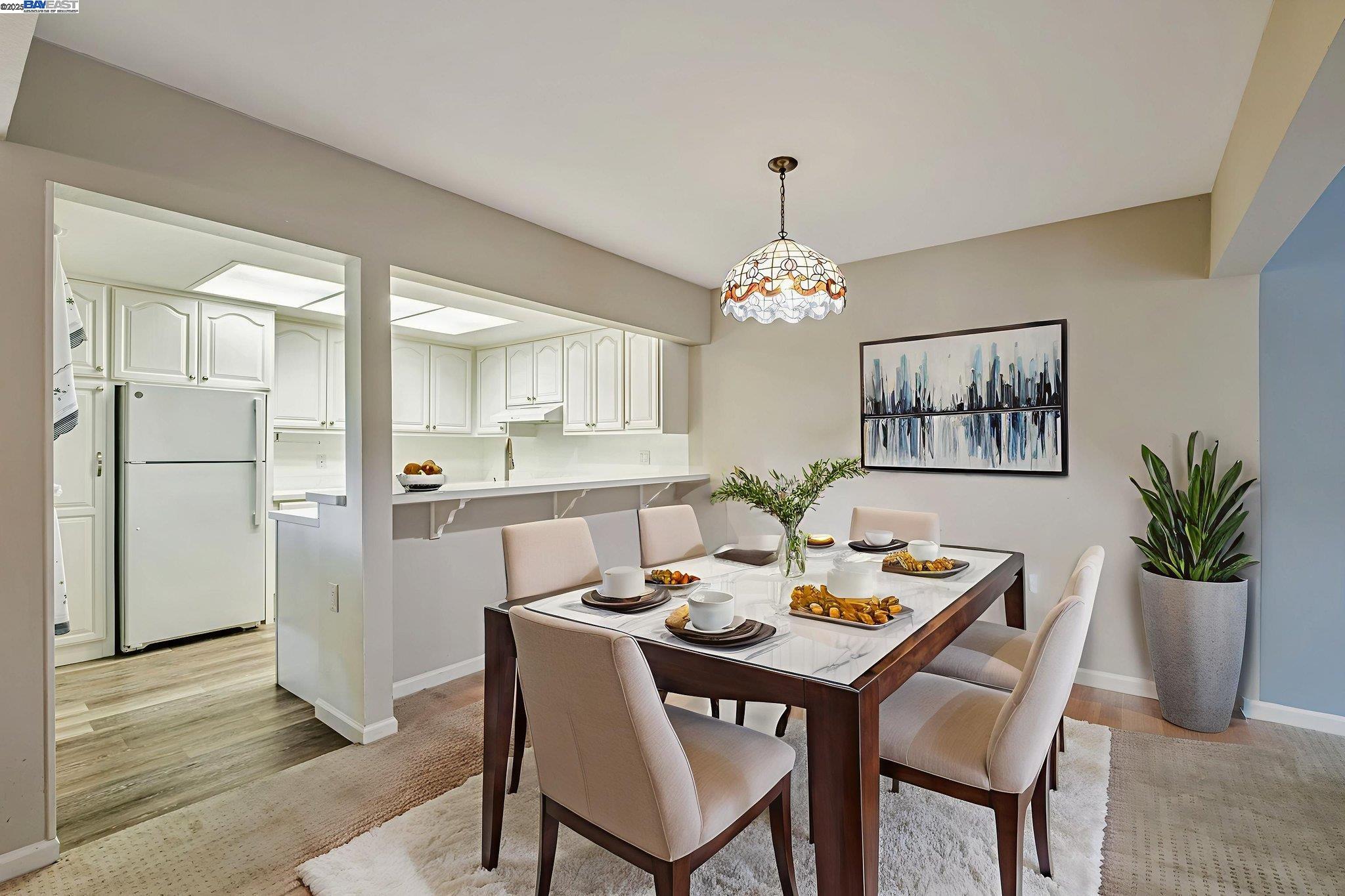 1400 Golden Rain Road, Unit 3 Walnut Creek, CA 94595 - Photo 7 of 29 a dining room with furniture a chandelier and wooden floor