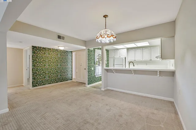 a view of a kitchen with large windows