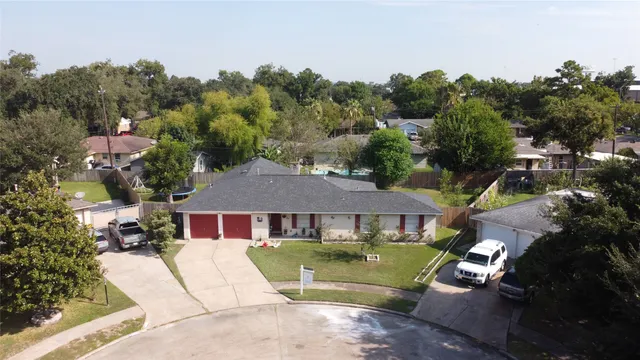 a aerial view of a house next to a yard