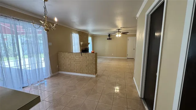 a view of a hallway with chandelier and entryway