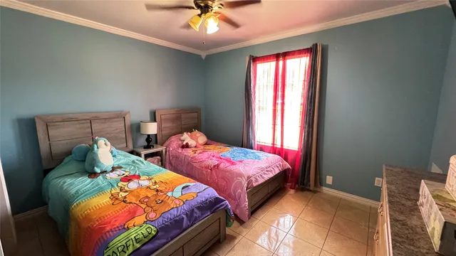 a bedroom with two beds and a chandelier