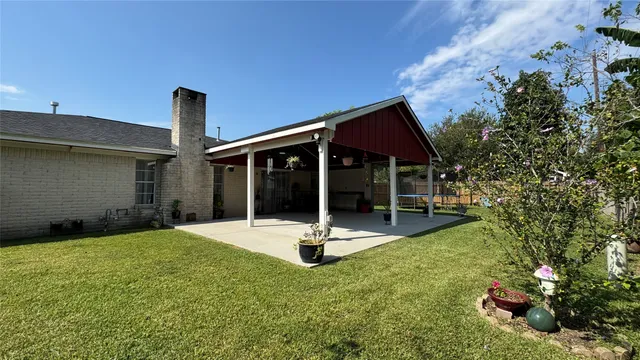 a backyard with table and chairs and potted plants