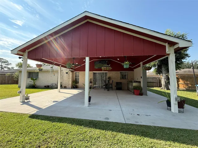 a view of a house with backyard and sitting area