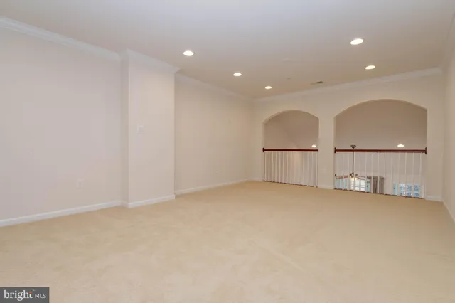 a bedroom with a bed and a potted plant on the dresser