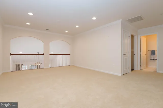 an empty room with a window and mirror