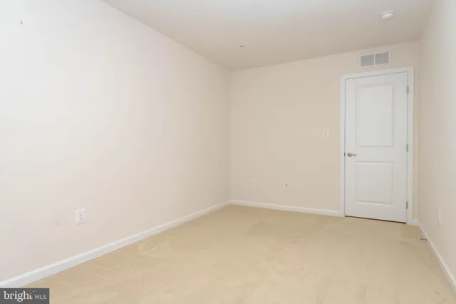 a big room with wooden floor and furniture