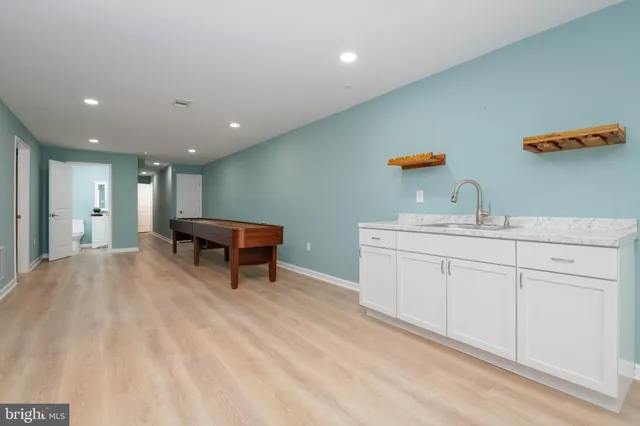 a view of empty room with wooden floor and windows