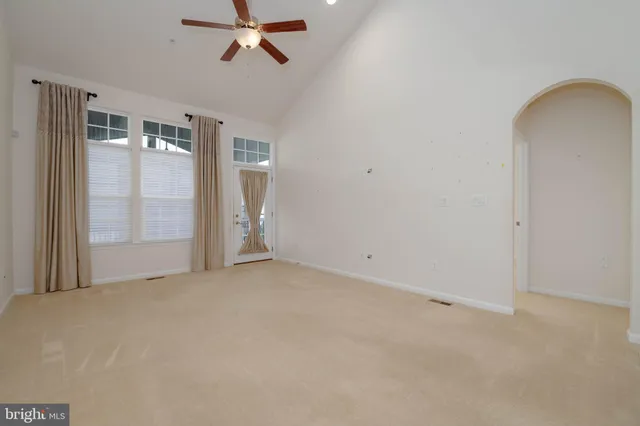 a living room with furniture a rug and a window