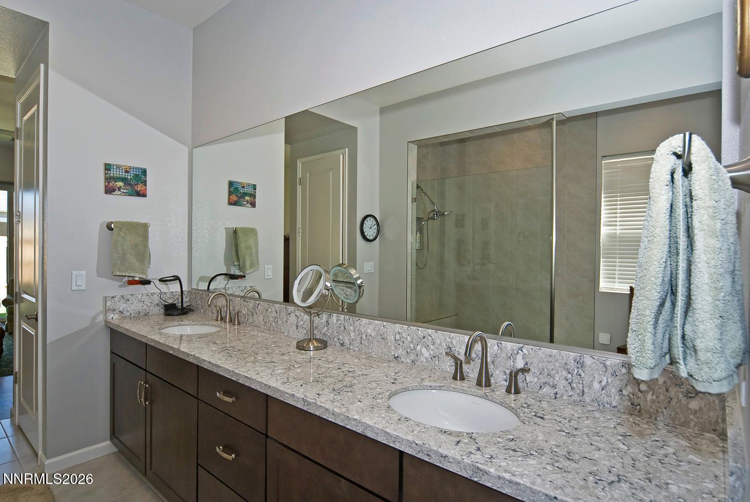 2332 Hammer Falls Drive Reno, NV 89521 - Photo 26 of 57 a bathroom with a granite countertop double vanity sink and mirror
