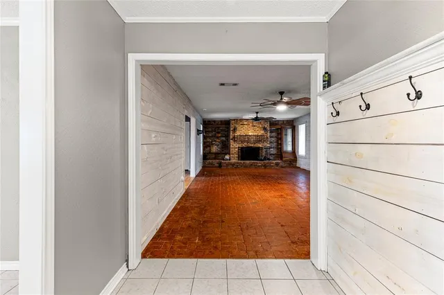 a view of a hallway with dining area and chandelier