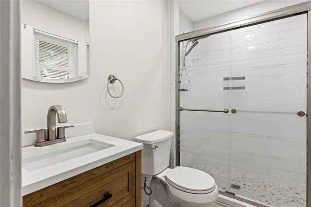 a front view of a house with a garden and trees