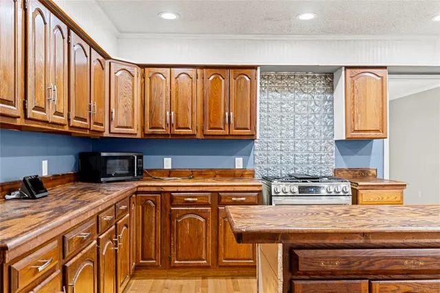 a kitchen with stainless steel appliances granite countertop a sink and cabinets