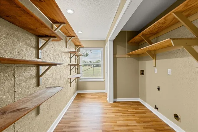a view of hallway with stairs and wooden floor