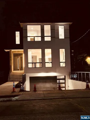 a front view of a house with car parked