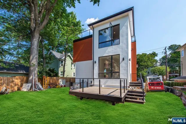 a large kitchen with stainless steel appliances a large counter top a stove and a refrigerator