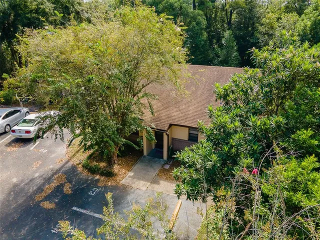 an aerial view of a house with a yard
