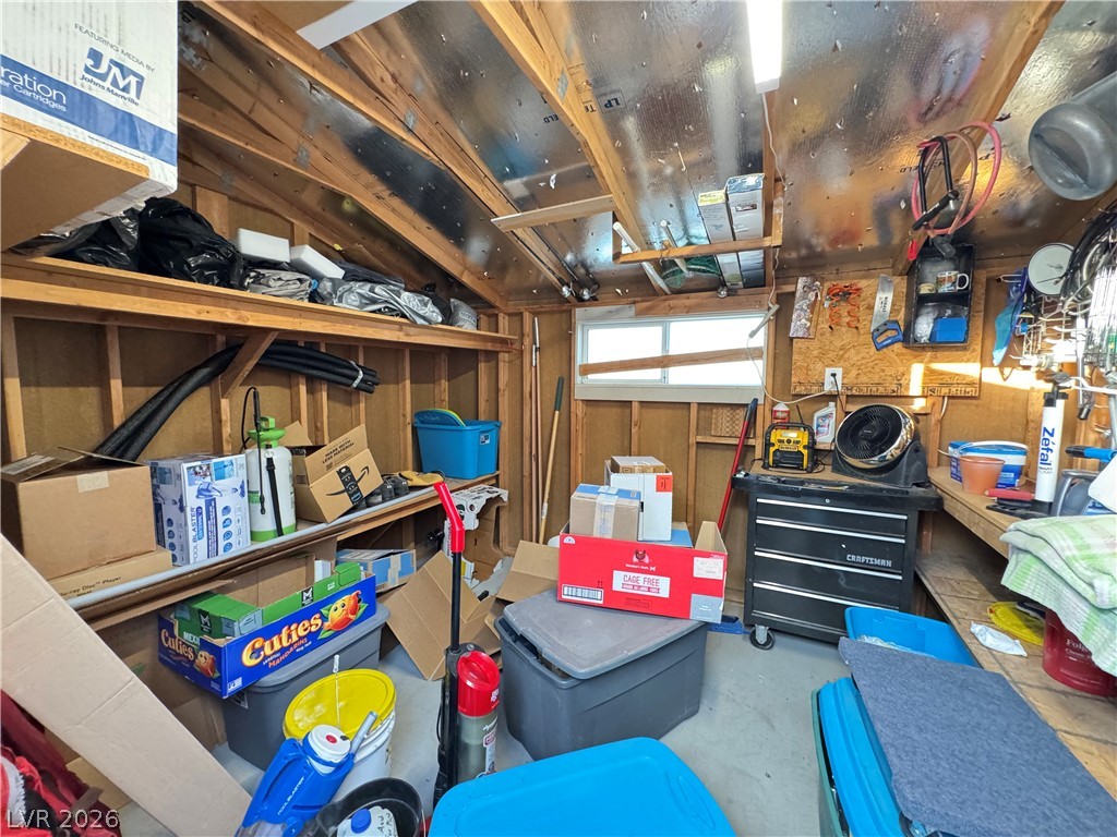 3250 Del Monte Street Laughlin, NV 89029 - Photo 53 of 57 A well-lit garage offers practical storage solutions with robust shelving and a clear window.