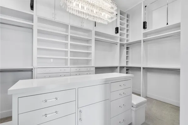 a view of walk in closet with empty racks