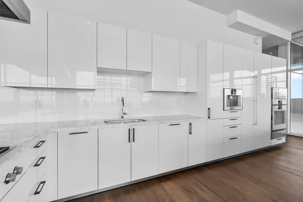 a kitchen with white cabinets and white appliances