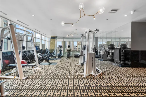 a view of a room with lots of gym equipment