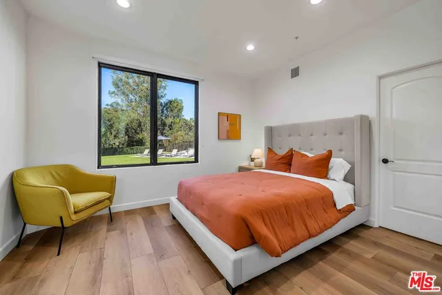 a bedroom with a bed and a couch