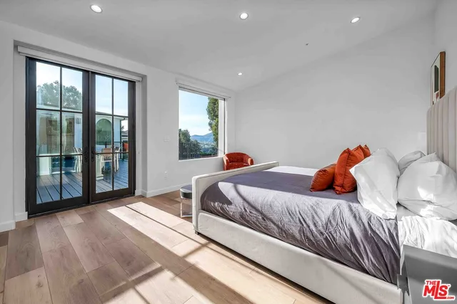 a bedroom with two beds and a window