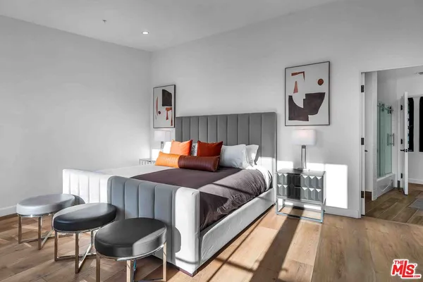 a bedroom with a bed and a chair