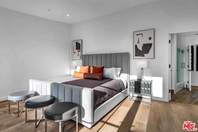 a bedroom with a bed and a chair