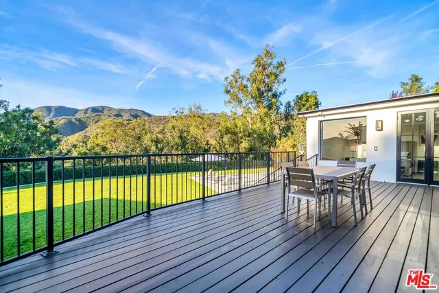 a view of a chairs and table on the wooden deck