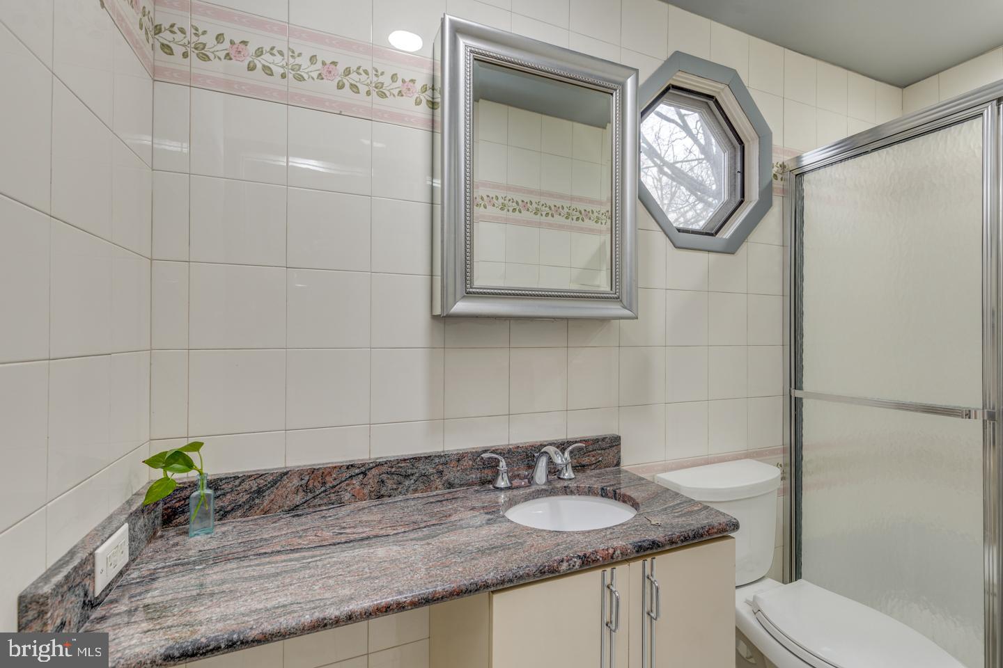 21 Ellis Street Haddonfield, NJ 08033 - Photo 18 of 23 a bathroom with a granite countertop toilet sink and mirror