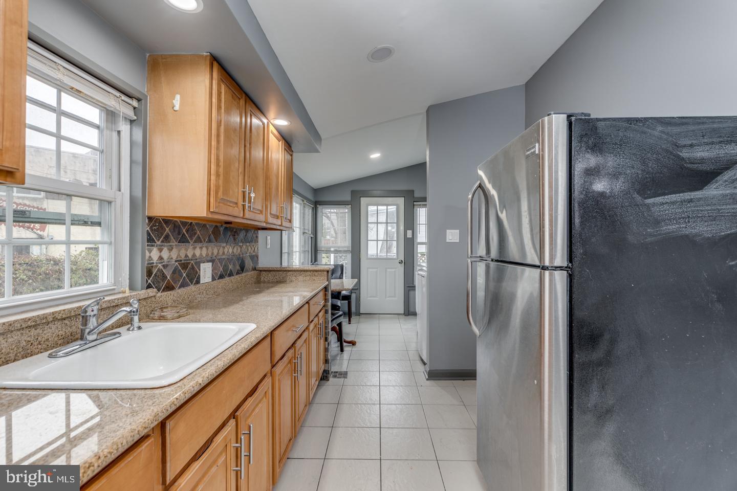 21 Ellis Street Haddonfield, NJ 08033 - Photo 6 of 23 a kitchen with a sink refrigerator and cabinets
