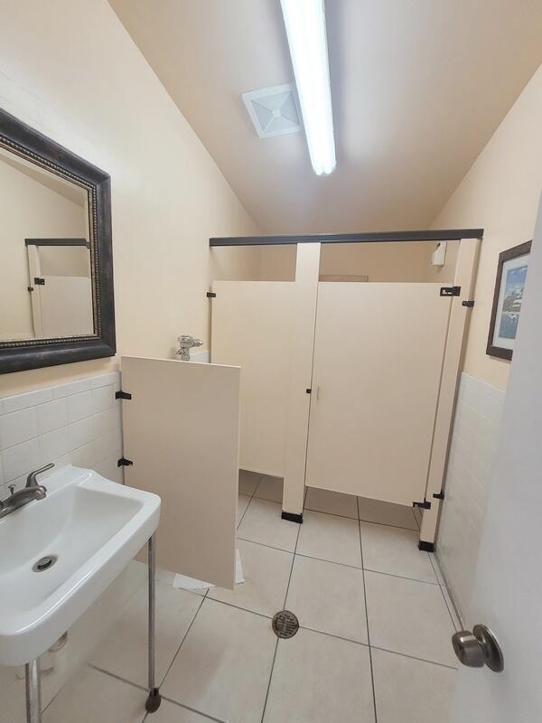 320 Pine Ridge Circle, Unit A1 Greenacres, FL 33463 - Photo 22 of 65 a bathroom with a sink a mirror and a shower