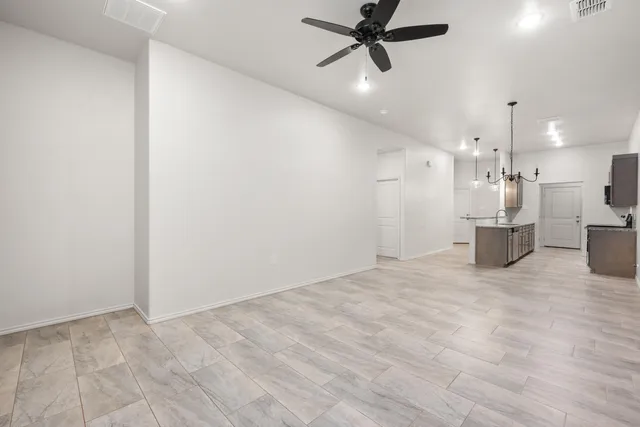 a view of a kitchen with a sink and a refrigerator