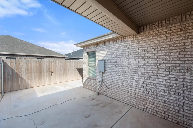 a view of an empty room with a brick wall