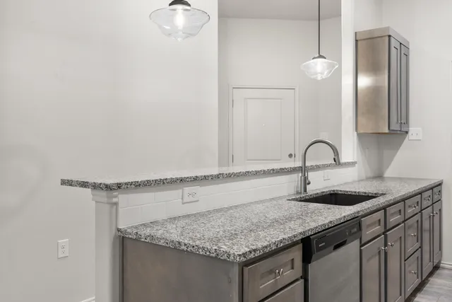a kitchen with a sink and cabinets